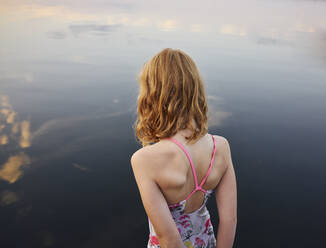 Girl standing at sea - JOHF06431