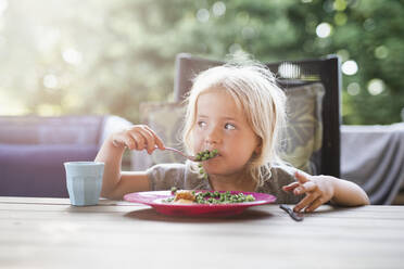 Girl having meal outside - JOHF06584