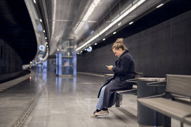 Frau wartet in der U-Bahn-Station - JOHF06835