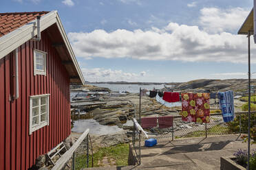 Red cottage by bay - JOHF07009