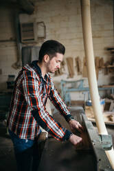 Carpenter working in a his private workshop - CAVF73895