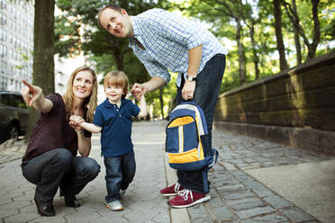 Parents walking son to preschool or daycare - CAVF74044