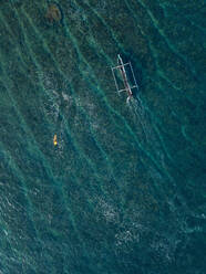 Aerial view of surfer and boat in the ocean - CAVF74104