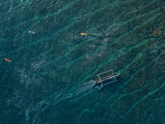 Aerial view of surfers and boat in the ocean - CAVF74107