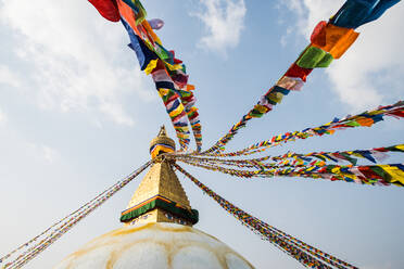 The Buddha Stupa strung with Prayer flags in Kathmandu Nepal - CAVF74193