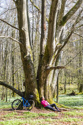 Cyclist resting in forest - JOHF07078