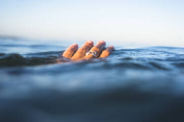 Hand in Ocean Water Surface Closeup - CAVF74269