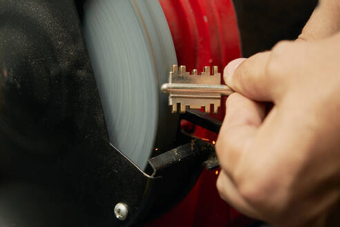 Closed image of duplicate key in the process of sanding by the locksmith to eliminate burrs - CAVF74281