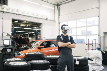 Automechaniker mit VR-Brille in einer Werkstatt - MOEF02735