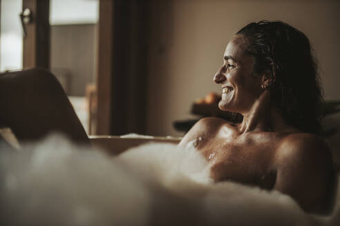Glückliche Frau entspannt in der Badewanne - DAWF01255