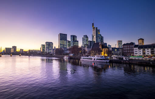 Deutschland, Hessen, Frankfurt, Skyline der Stadt am Wasser in der Abenddämmerung - AMF07802