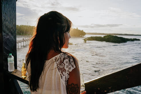 Woman watching the sunset on Siargao Island, Philippines - FAF00085