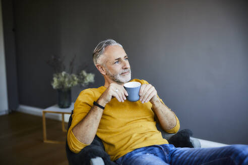 Relaxed mature man at home with cup of coffee - FMKF06103