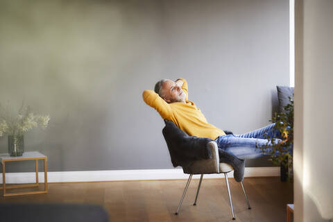 Mature man relaxing at home stock photo