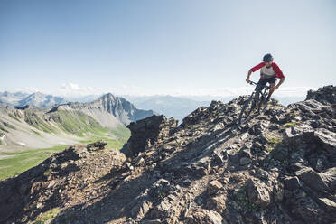 Mountainbiker im Abendlicht in Graubünden, Schweiz - HBIF00003