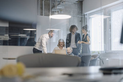 Business team with a boy having a meeting in office stock photo