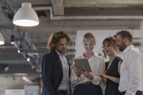 Business team having a meeting in office sharing a tablet - KNSF07476