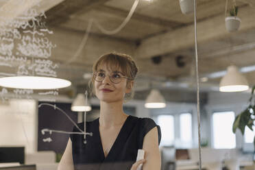 Businesswoman working on a project in office - KNSF07499