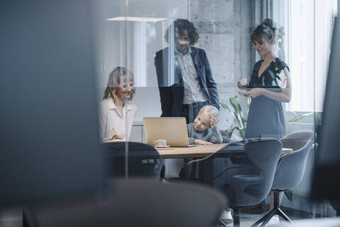 Business team with boy having a meeting in office stock photo