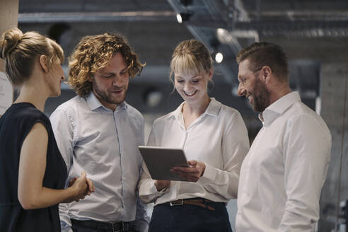 Business team having a meeting in office sharing a tablet - KNSF07580