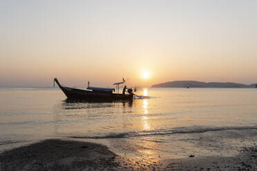 Longtail boat on the sea at sunset, Noppharat Thara Beach, Ao Nang, Krabi, Thailand - CHPF00605