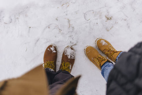 Couple wearing leather boots in winter - KNTF04177