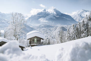 Germany, Bavaria, Berchtesgaden, Mountain hut and Watzmann in deep snow - JRAF00018