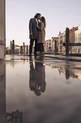 Affectionate young couple kissing in the city of Venice, Italy - MAUF03299