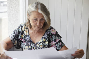 Woman looking at documents - JOHF07579