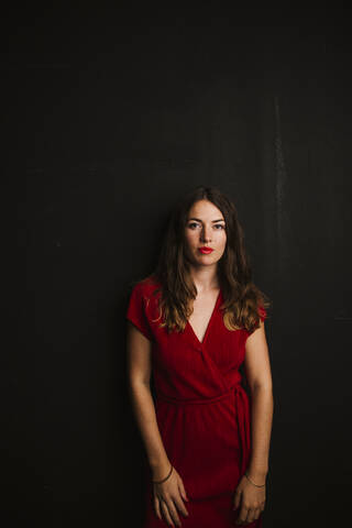 Portrait of young woman wearing red dress stock photo