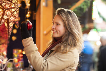 Frau beim Einkaufen von Weihnachtsschmuck, Weihnachtsmarkt, Freiburg, Deutschland - CUF54694