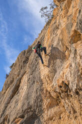 Man climbing at rock face - DLTSF00452