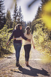 Mother hiking with daughter in the mountains, rear view - DHEF00115