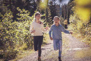 Girls running and having fun on a forest path in the countryside - DHEF00122