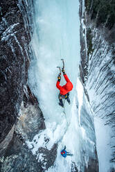 Mann beim Eisklettern an der Cathedral Ledge in North Conway, New Hampshire - CAVF74354