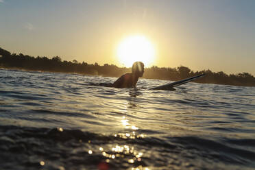 Surfer at sunset, Bali, Indonesia - KNTF04284