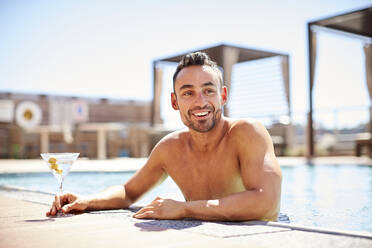 A man enjoying a martini in the pool. - CAVF74537