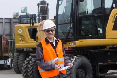 Worker outside with a protocol in front excavators - CAVF74595