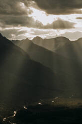 Golden light bursts through clouds into beautiful mountain valley - CAVF74625