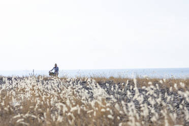 Woman walking with bicycle - JOHF07753