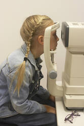 Girl having eye test - JOHF07783