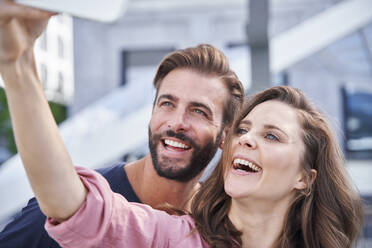 Happy couple taking a selfie in the city - PNEF02229