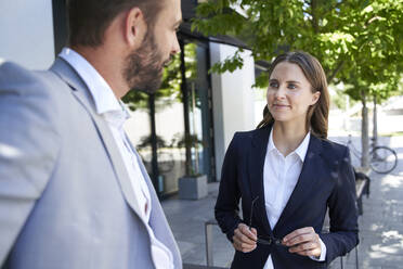 Businessman and businesswoman talking in the city - PNEF02286