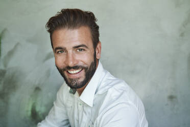 Portrait of happy businessman wearing white shirt - PNEF02314