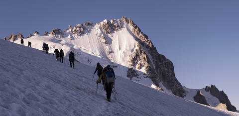 France, Mont Blanc Massif, Chamonix, Mountaineers climbing Aiguille de Chardonnet in the snow stock photo