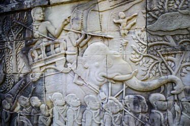 Ankor Wat, a 12th century historic Khmer temple and UNESCO world heritage site. Arches and carved stone bas relief panels with scenes from Khmer cultural history. - MINF13408