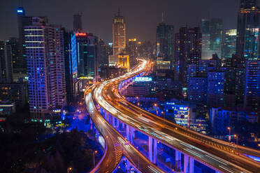 Elevated view of stacked road junction & Shanghai skyline at dusk, Shanghai, China - MINF13593