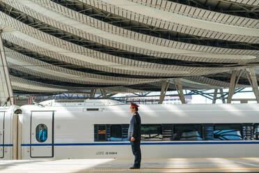 Guard by Maglev train in the railway station, Beijing, China - MINF13611