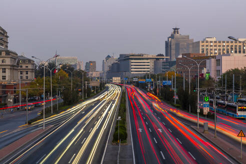 Traffic trail lights on major road near Beijing Zoo at dusk, Beijing, People's Republic of China, Asia - RHPLF13726