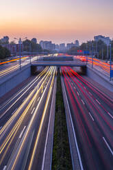 Traffic trail lights on major road near Beijing Zoo at dusk, Beijing, People's Republic of China, Asia - RHPLF13728